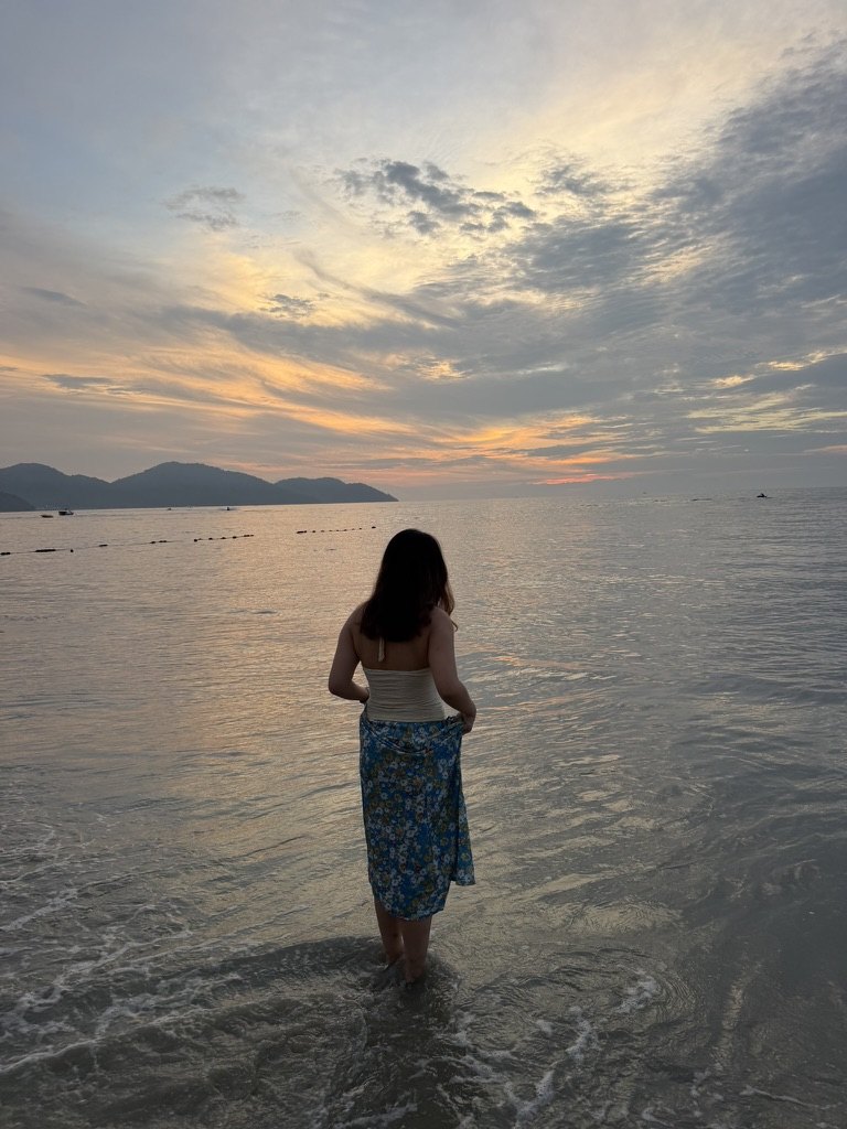 Esther standing at the sea in Penang at sunset
